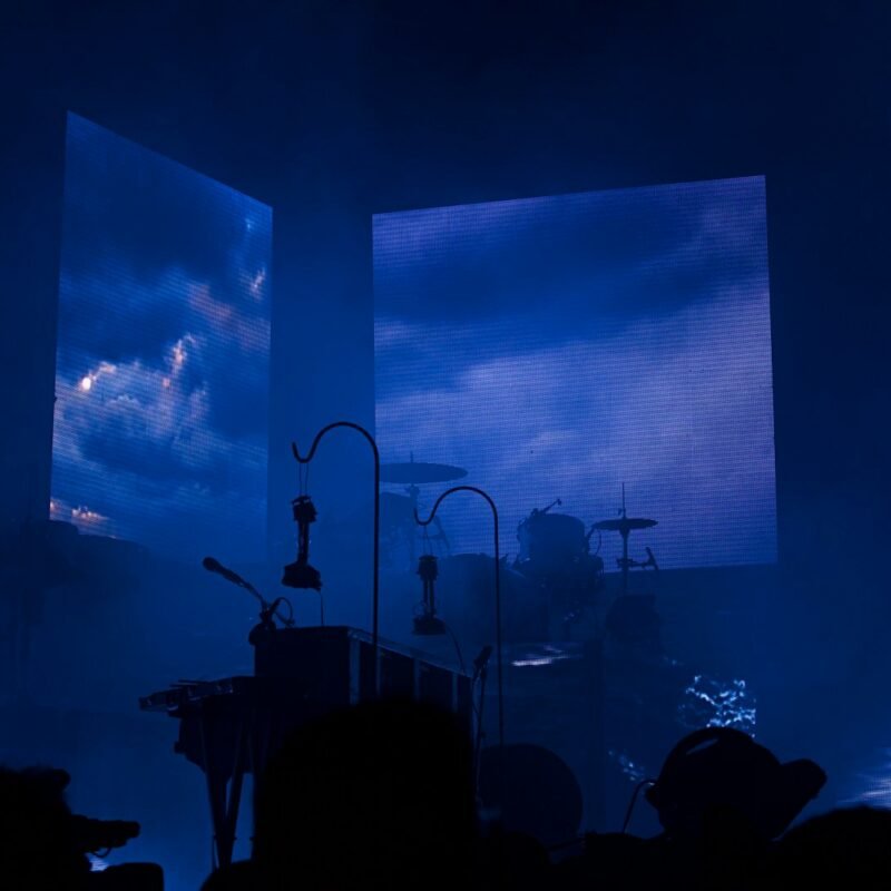 a group of people that are standing in front of a stage