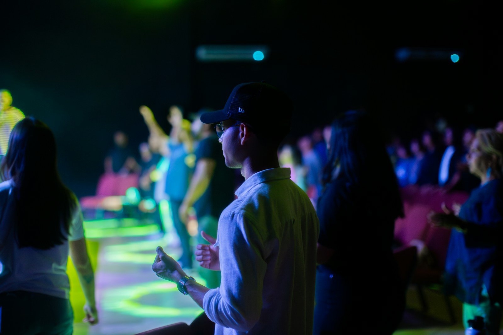 A group of people standing around a dance floor